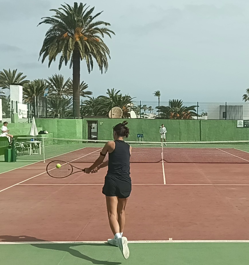 Tessa working on her backhand during a tennis retreat on court in Corralejo